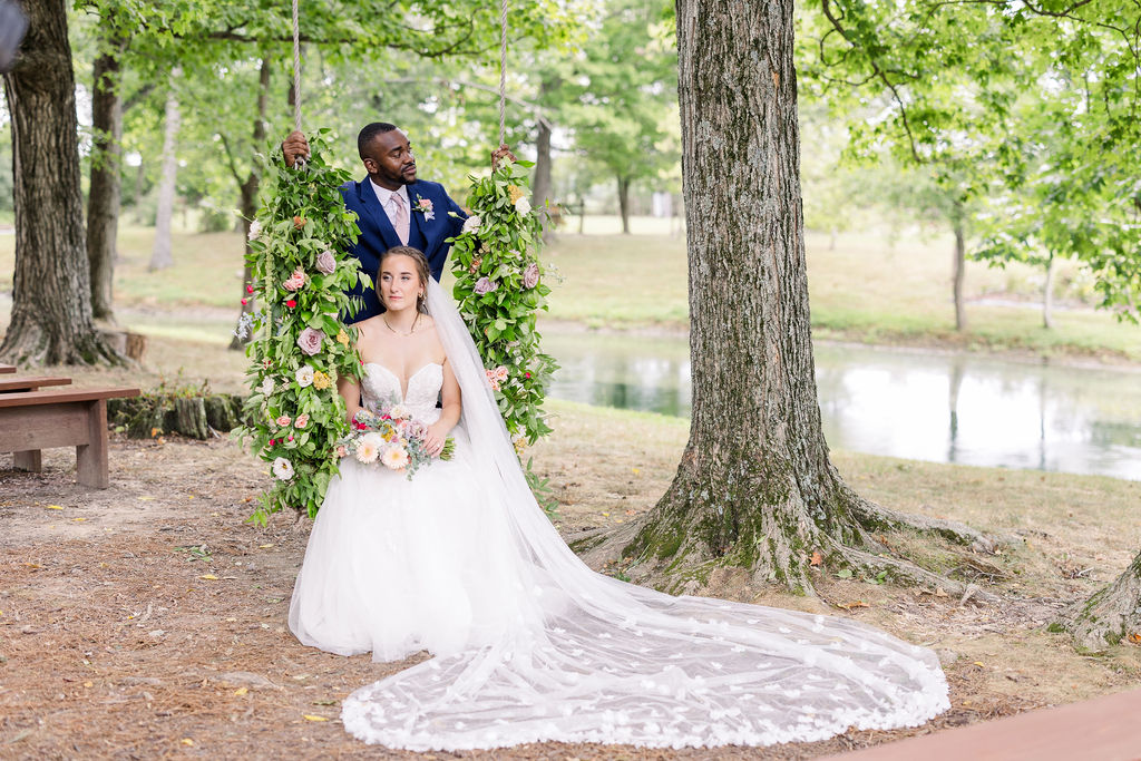 Portrait of bride and groom on the swing at The Marmalade Lily