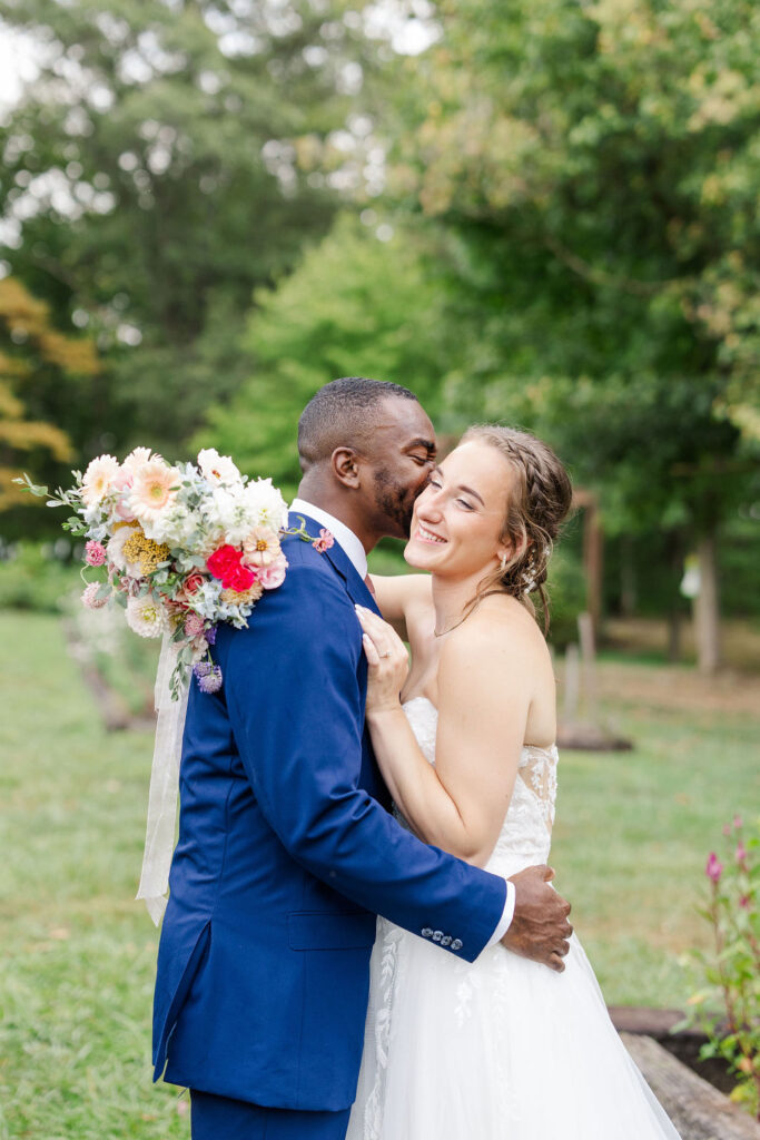 Portrait of bride and groom in gardens at the marmalade lily