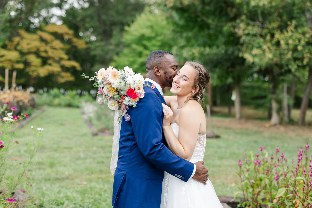 Portrait of bride and groom in gardens at the marmalade lily