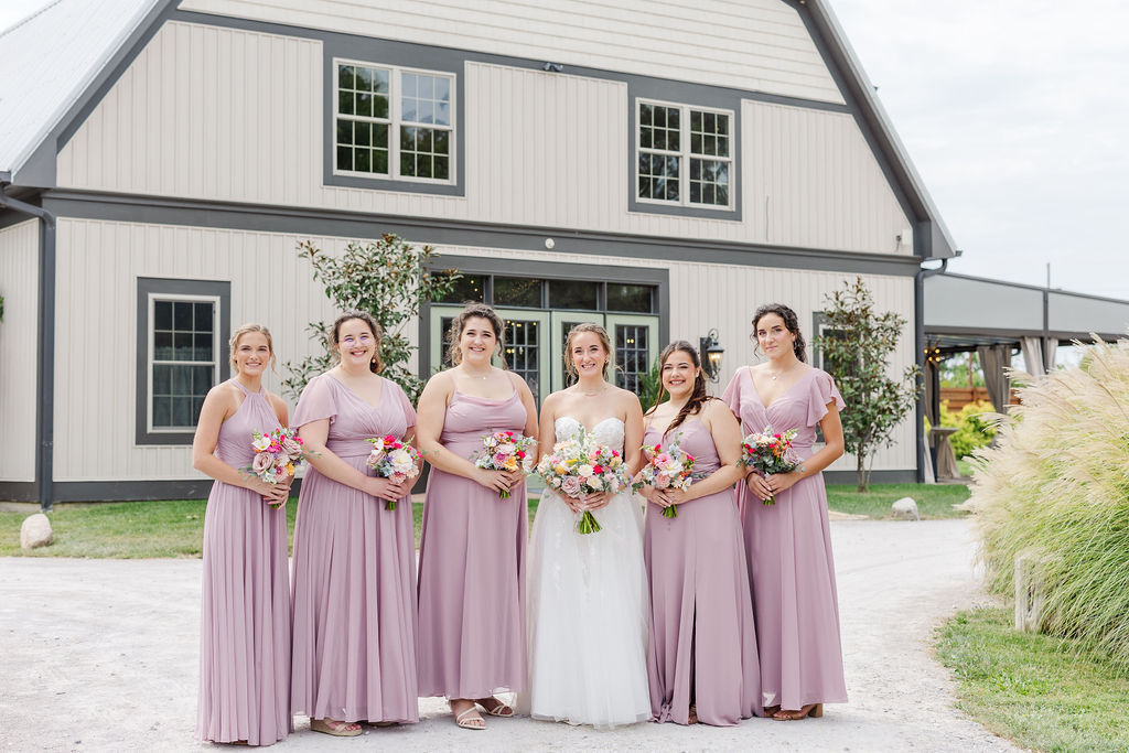 Bridesmaids in front of the barn at The Marmalade Lily