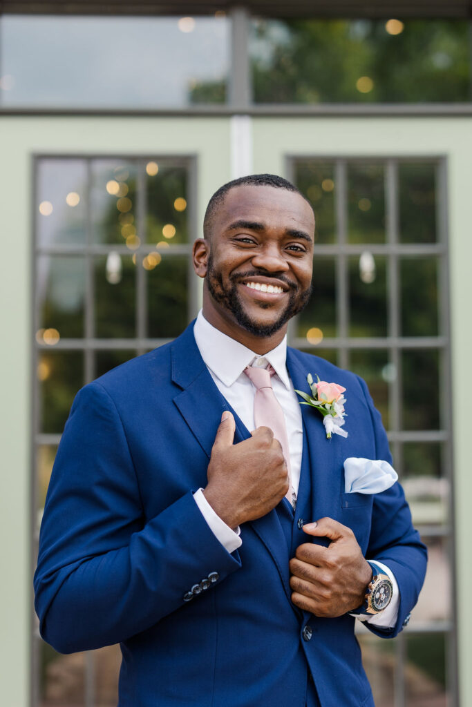 Portrait of groom in front of barn at the marmalade lily