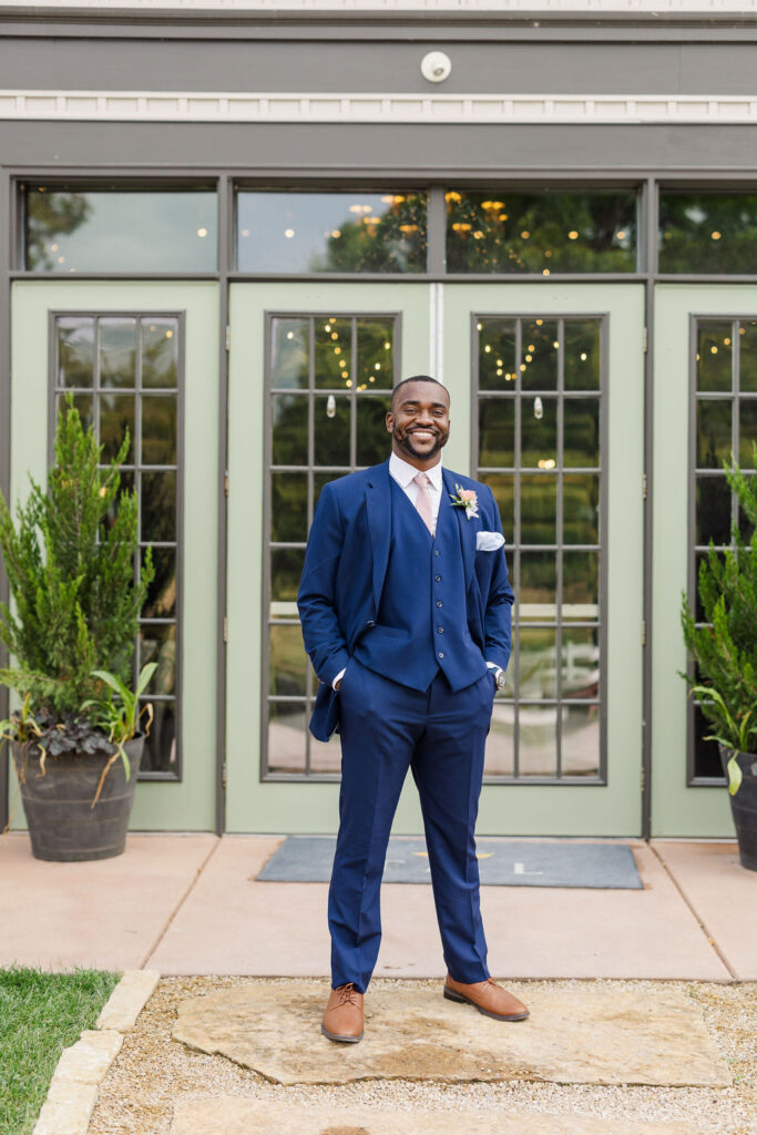 Portrait of groom in front of barn at the marmalade lily