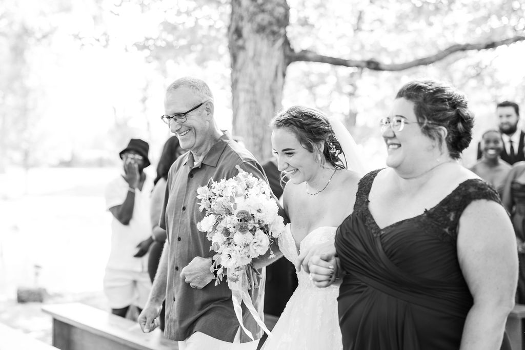 Bride walking up the aisle of the marmalade lily 