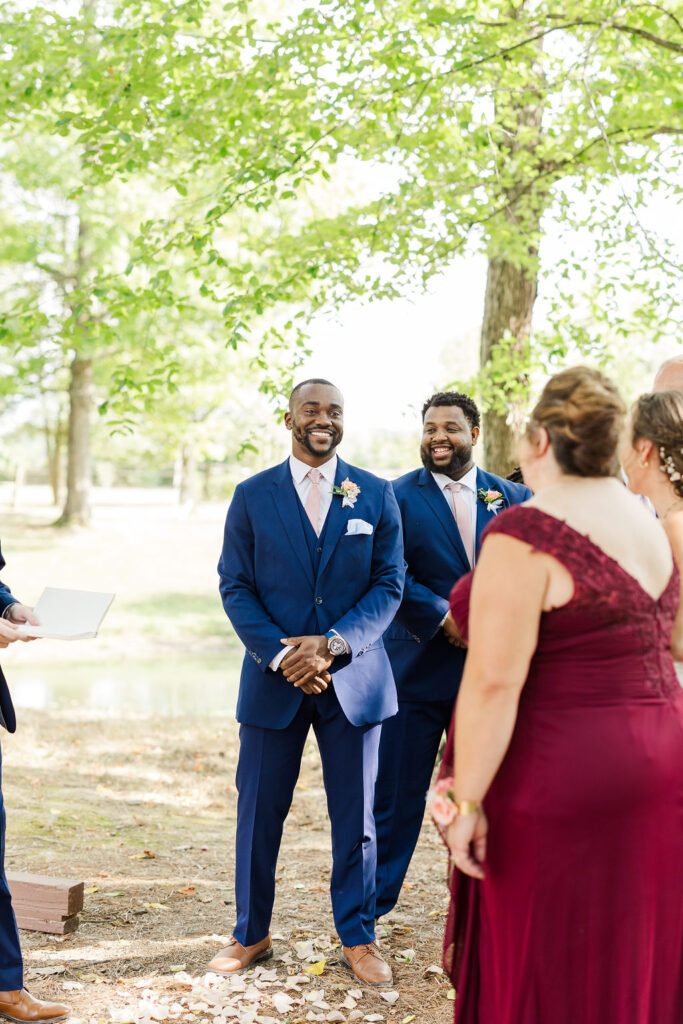 Photo of groom seeing bride walk down the aisle at the marmalade lily