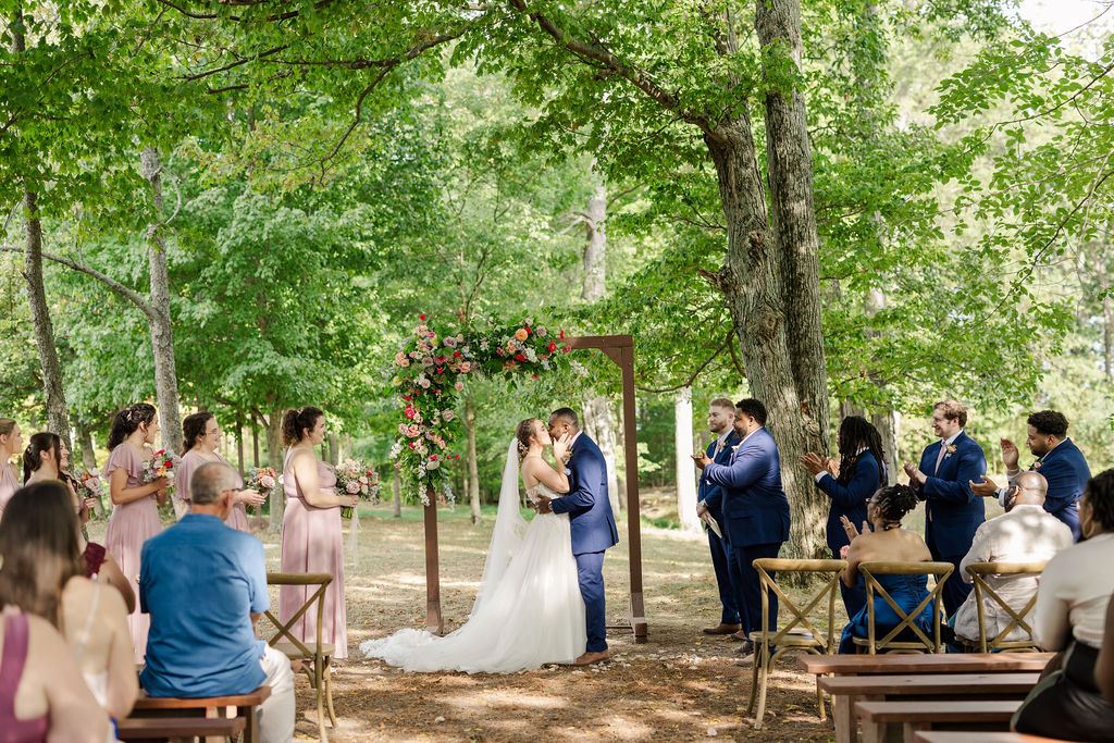 Bride and groom's first kiss during the ceremony at the marmalade lily