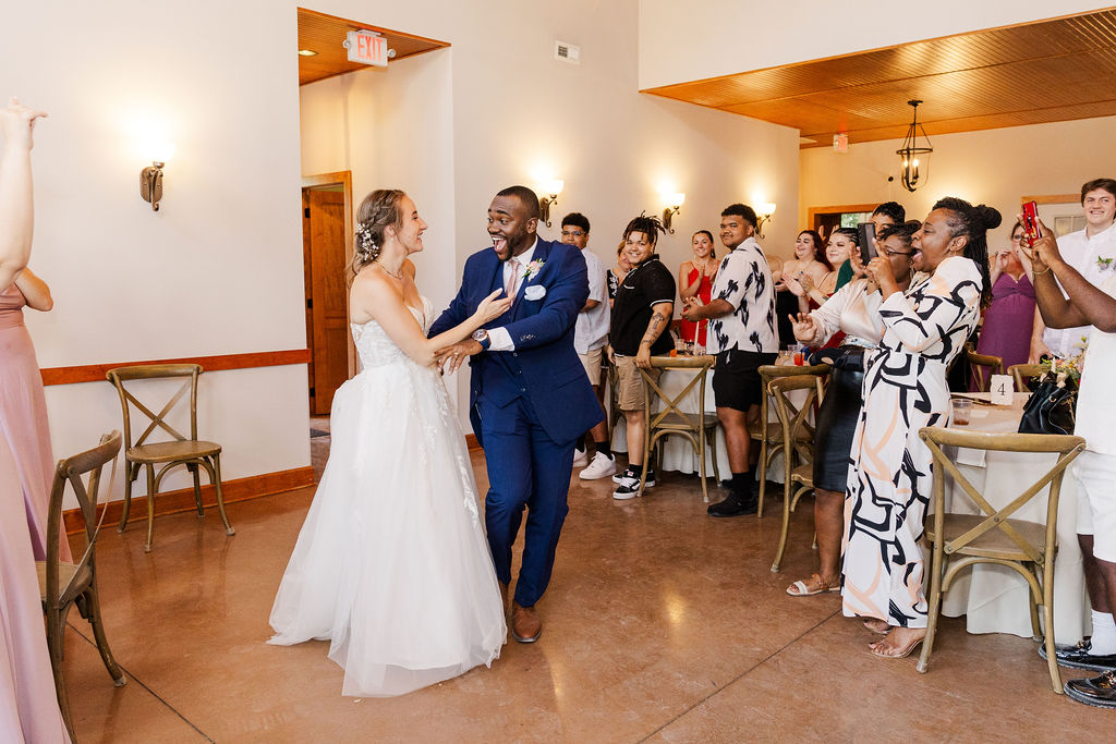 Bride and groom's entrance to reception at the marmalade lily 