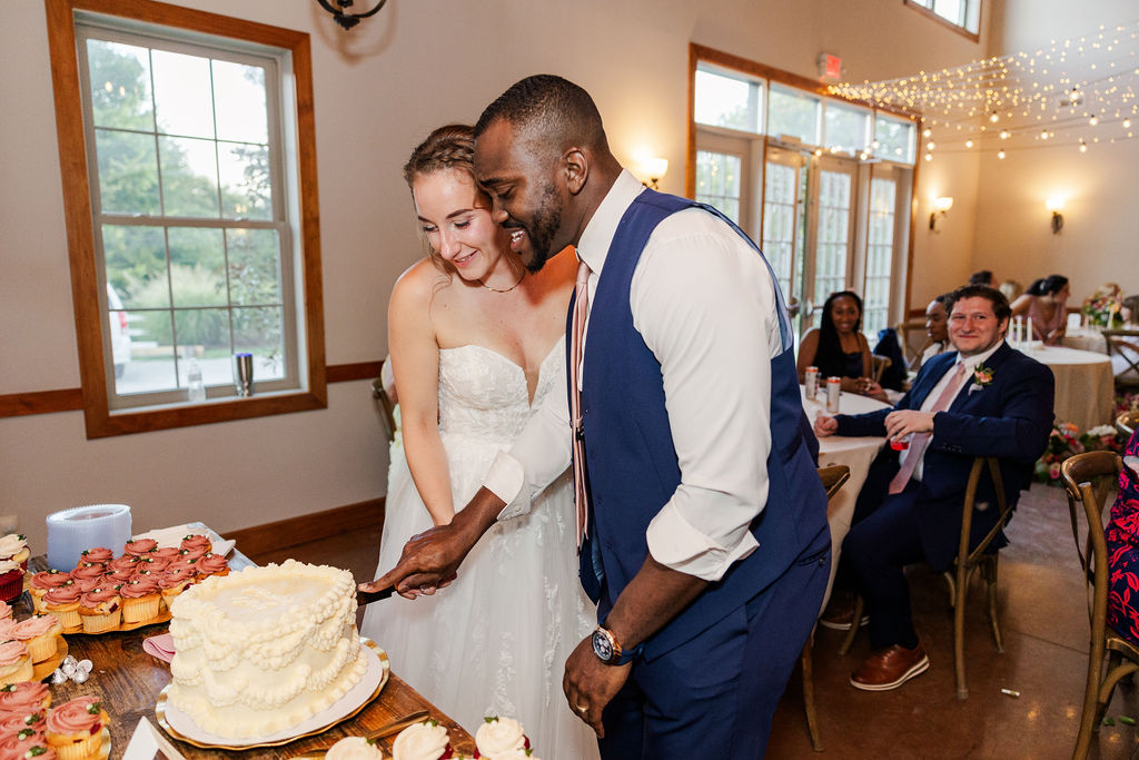 Bride and groom cutting cake at the marmalade lily