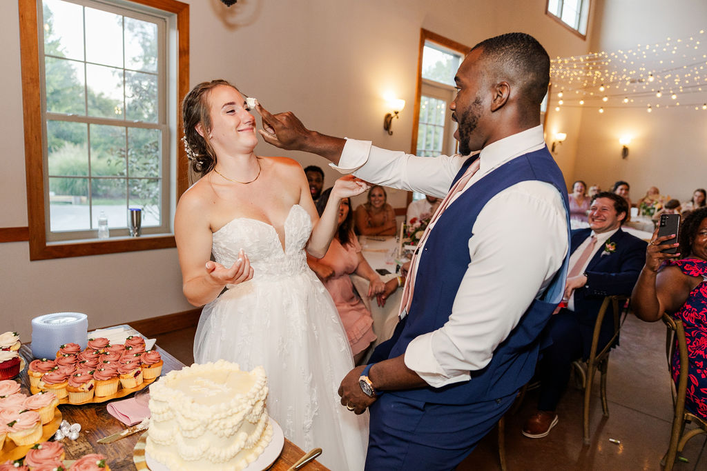 Bride and groom cutting cake at the marmalade lily