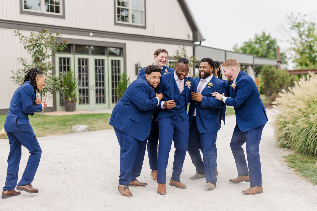 Groomsmen in front of the barn at The Marmalade Lily